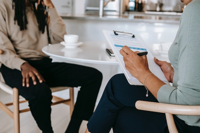 people sitting at table with checklist for tenant screening