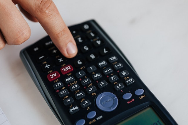 hand-pressing-calculator-button